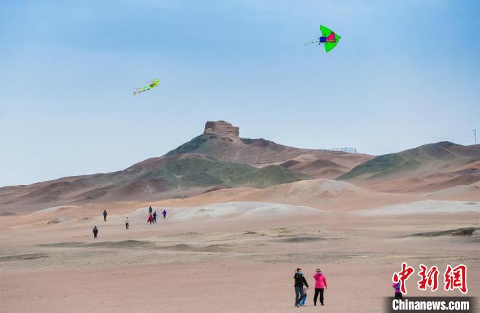 圖為市民正在陽關(guān)景區(qū)放風(fēng)箏。　王斌銀 攝